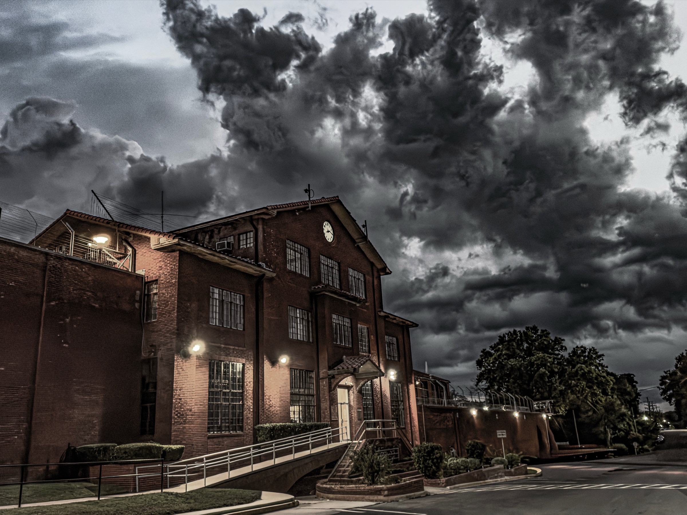 The historic Huntsville Unit at dusk under a stormy sky
